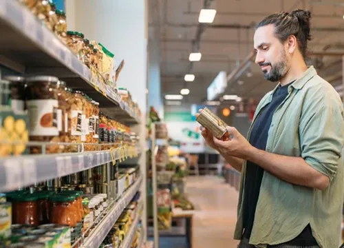 A man shopping in a retail store checking out a product