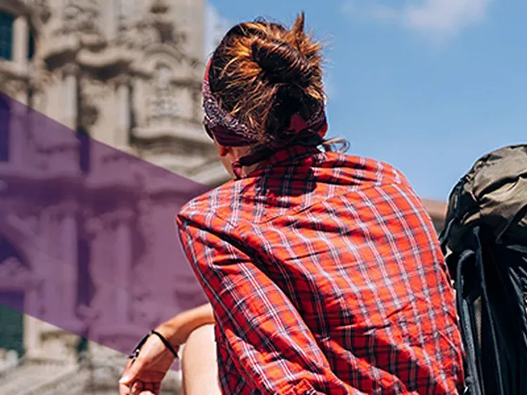 A traveller sitting and watching building