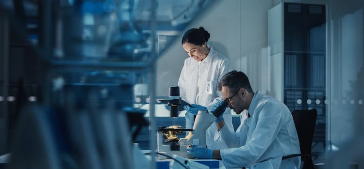 Scientists are observing something in an laboratory.