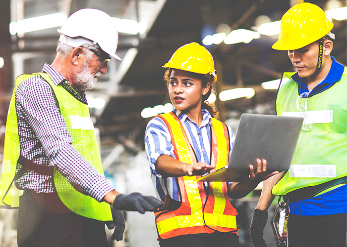 3 factory workers discussing 