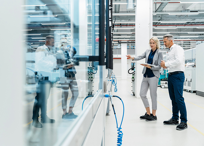 two employees discussing in a factory