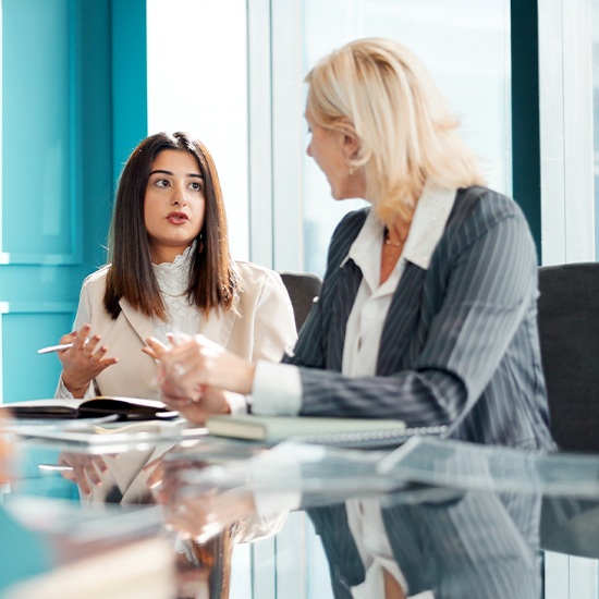 two professionals women discussing work