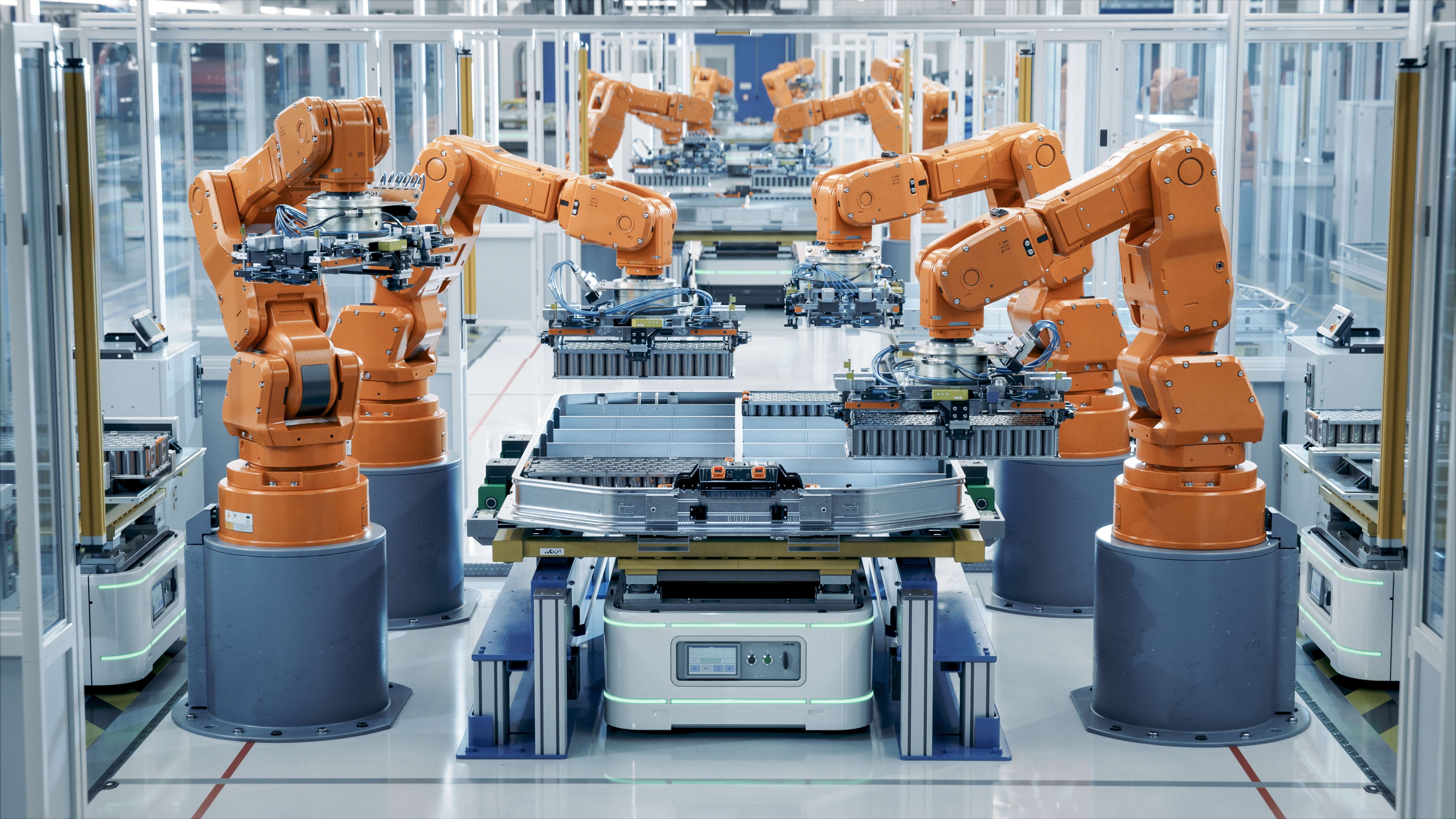 Row of Robot Arms inside Bright Plant Assemble Batteries for Automotive Industry. EV Battery Pack Automated Production Line Equipped with Orange Advanced Robotic Arms. Electric Car Smart Factory; Shutterstock ID 2374437797; purchase_order: 3057356; job: GBC; client: India; other: Campaigns