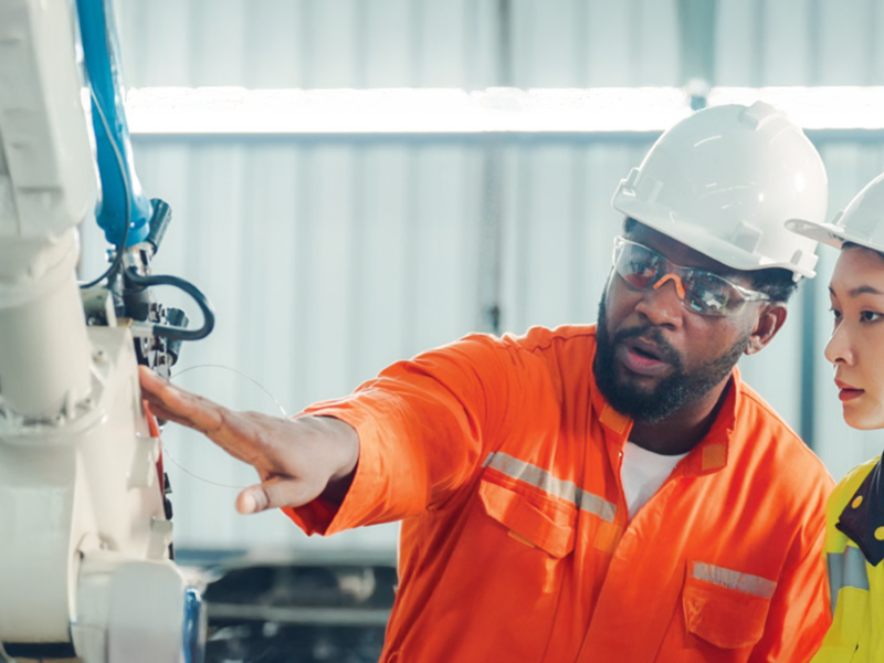 Two people observing item work environment
