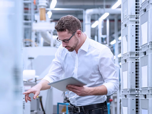 A male employee working in a warehouse environment.