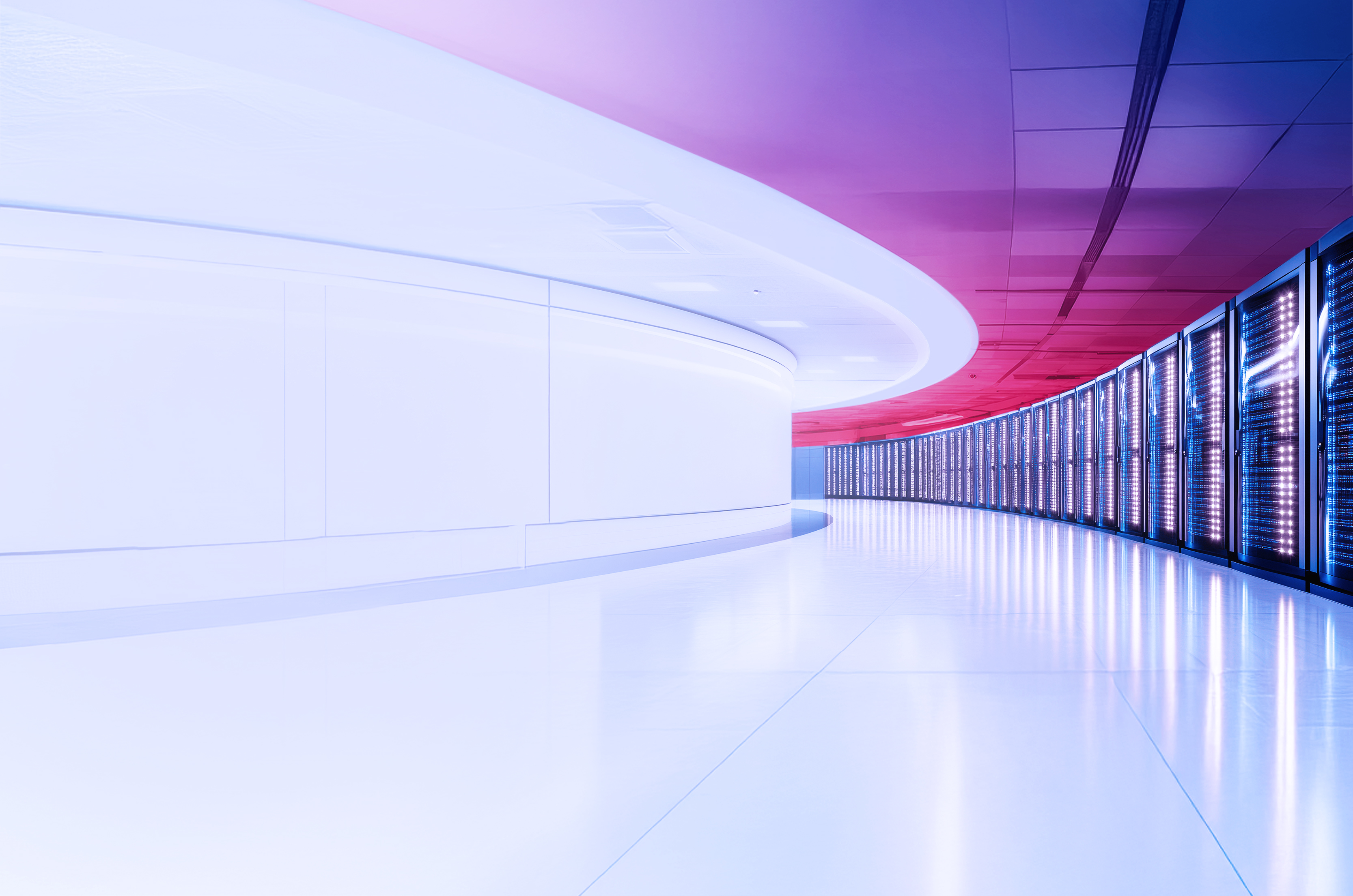 A room with digital display on the wall on the left and stacked servers on the right
