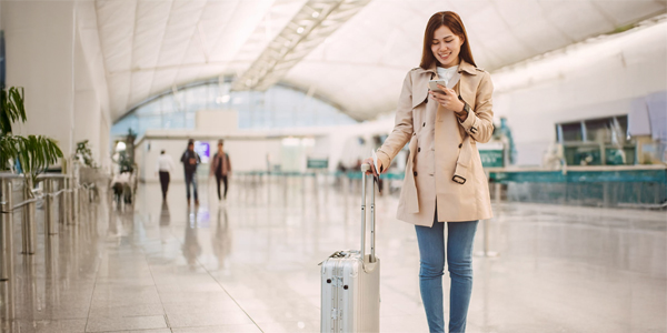 A lady passenger walking through an airport