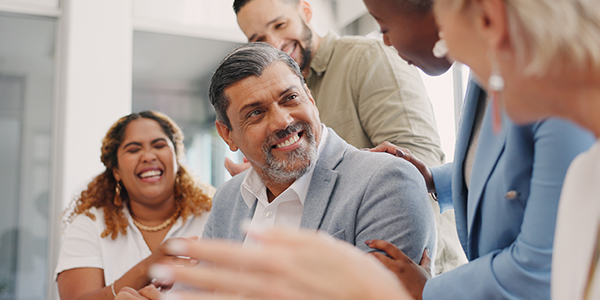 Hispanic person talking to colleagues 