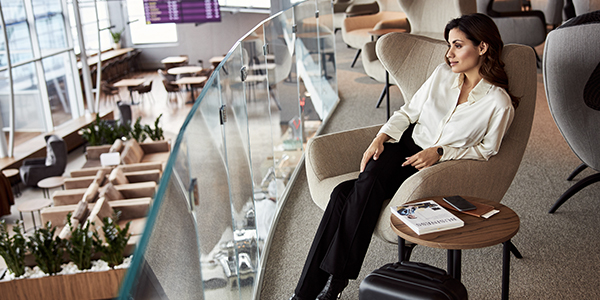 A traveller siting on a chair in a lounge