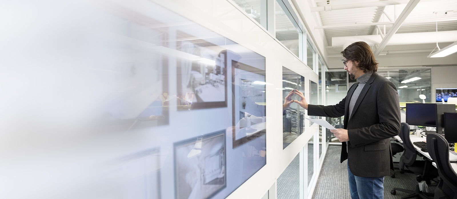 Businessman using multiple interactive screens
