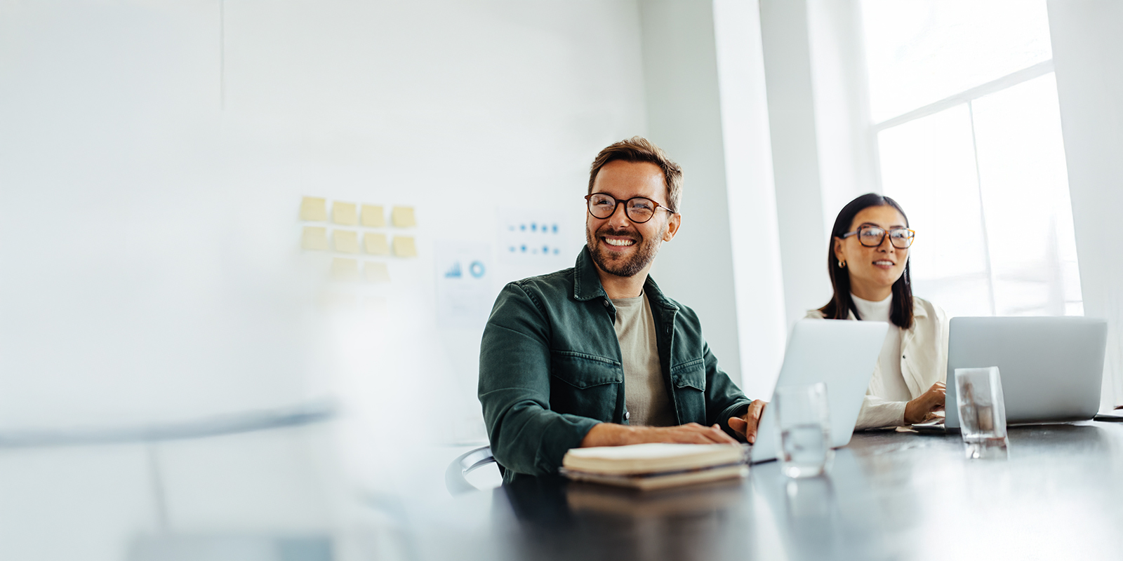 Two people are sitting on a table and smiling