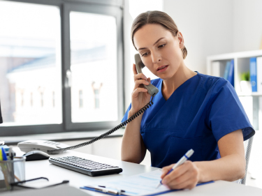 A woman speaking on a telephone