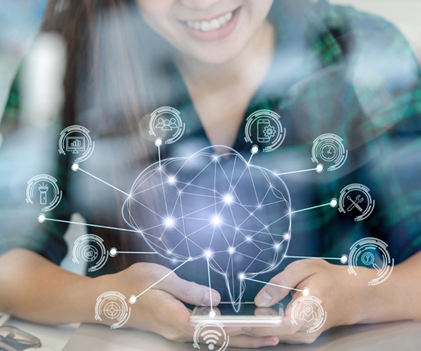 Woman holding mobile phone and credit card in each hand