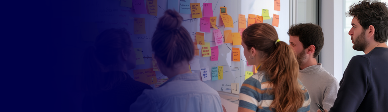 A lady standing at an event next to a white board with sticky notes.