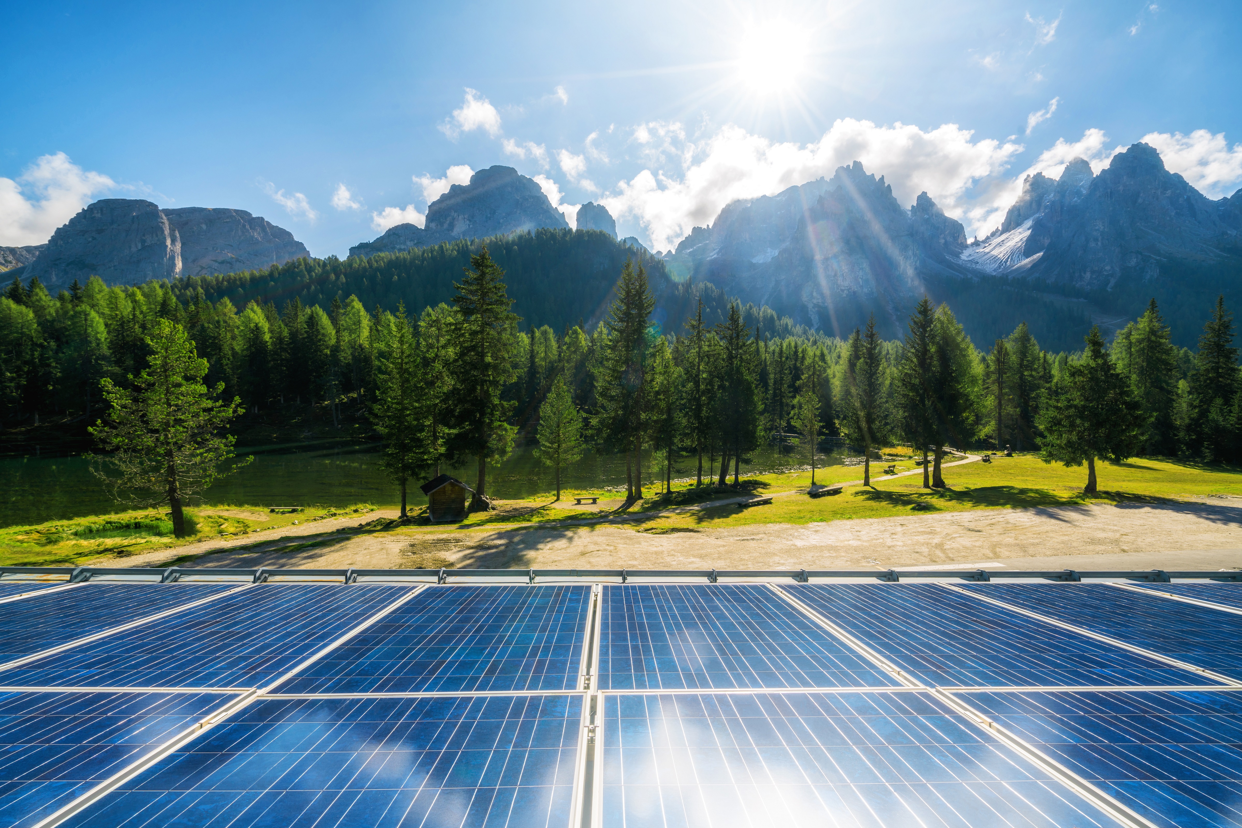 Solar cell panel in country landscape against sunny sky and mountain backgrounds. Solar power is the innovation for sustainability of world energy. Sustainable resources.