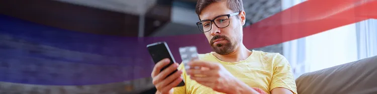 A man is checking the medicine on his phone