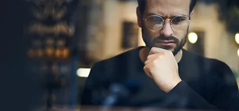 A man thinking with hand on his chin