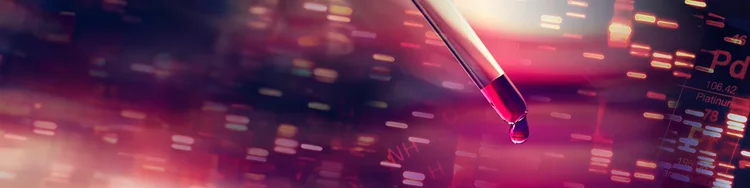 A dropper pouring red liquid