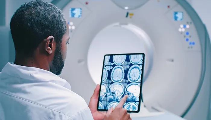 A doctor reviewing medical scan report in tablet