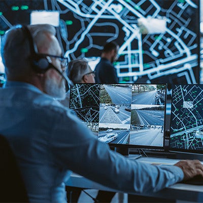 A man with headphones on, working on his computer