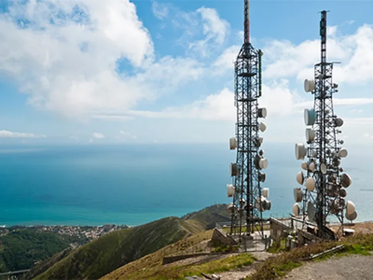 Two satelite towers atop a hill