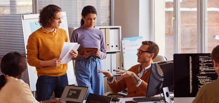 A group of software developers in an office meeting