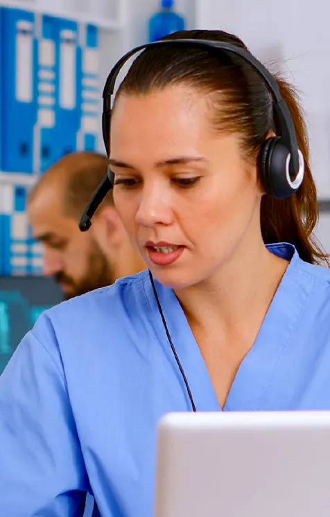 Female healthcare using a laptop and a headphone set