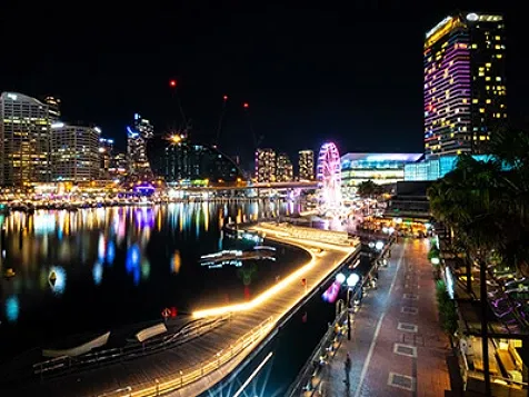 Cityscape at night next to a waterbody