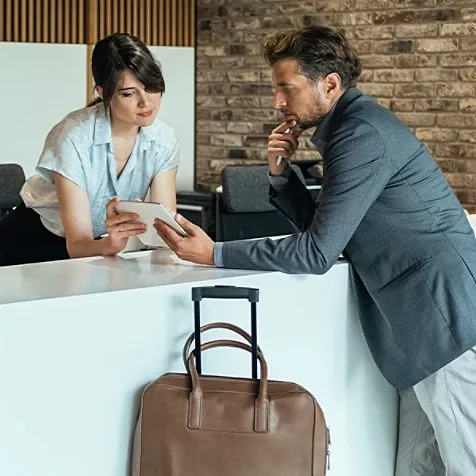 A receptionist attending to a customer.