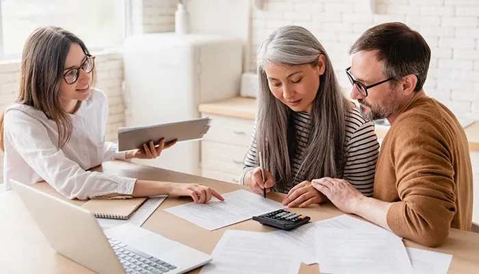 A team reviewing a reports infront of laptop
