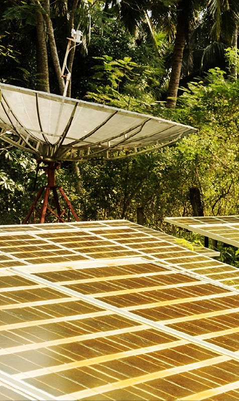 Dish antenna next to solar panels