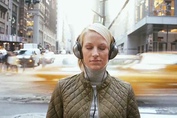 Woman listening to music through headphones