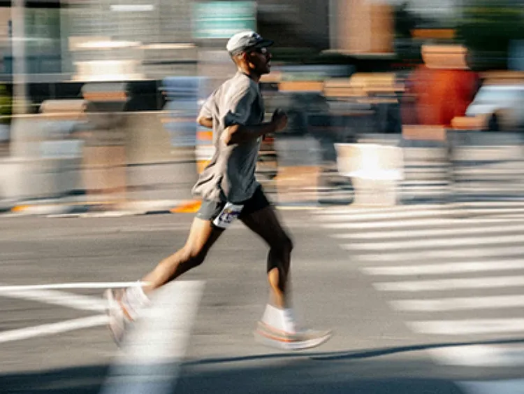 Runner crossing a city street.