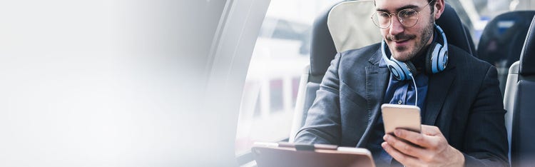 A man watching something on this tablet while travelling