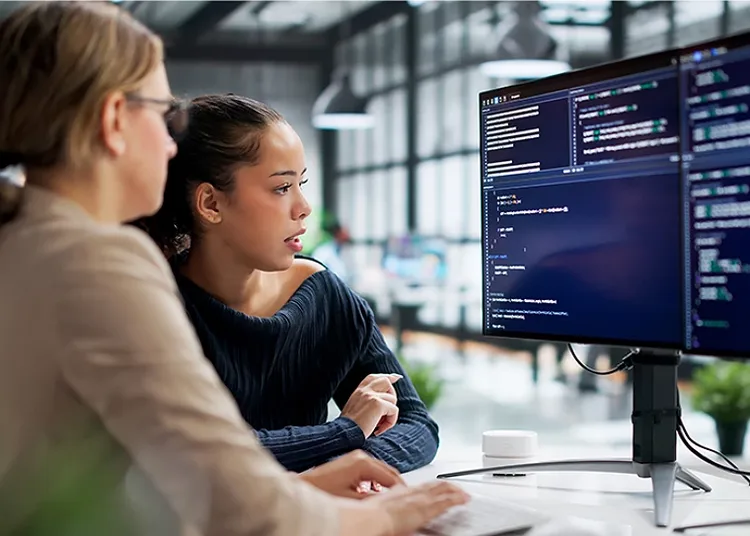 Two women looking at a computer screen