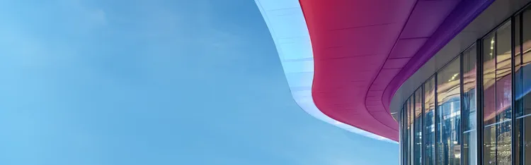 A glass fronted building with red awning