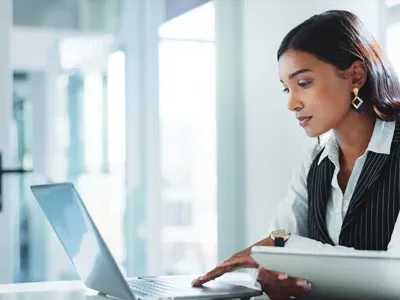 A professional female employees working on her laptop.