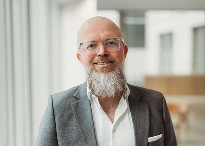 A person is speaking to a mic sitting on a table