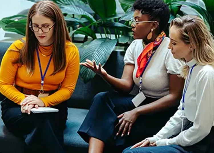 A group of female colleagues sitting together and discussing