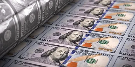 Sheets of $100 bills being rolled out