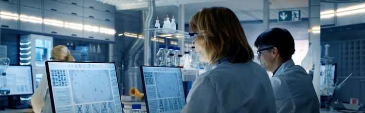 Image of a man at a screen displaying biological cells
