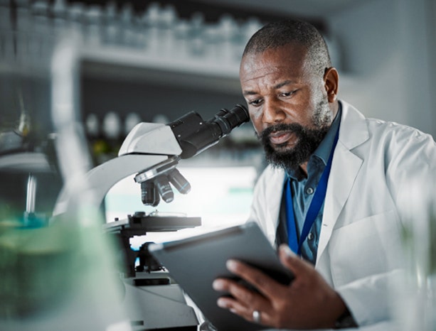 A life sciences healthcare professional explaining something on a live video call on a laptop