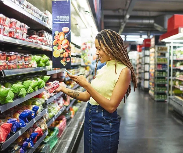 A woman browsing a retail store aisle