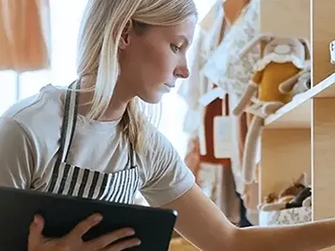 A women holding tab and checking something