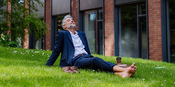 A man sitting on a grass and relaxing