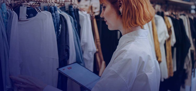 A person checking clothes at a retail store