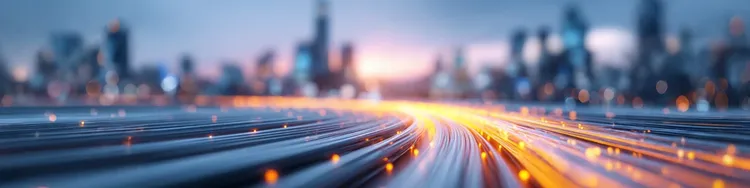 Abstract image depicting vibrant city lights and flowing traffic on a busy highway at night.