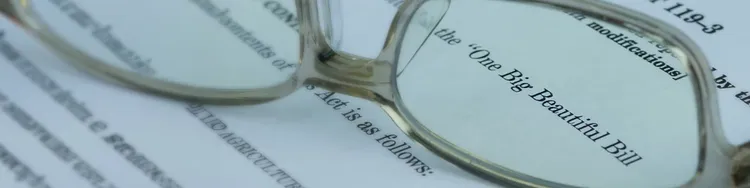 A document with a pair of glasses placed on top, indicating a focus on reading or studying.
