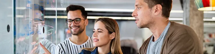 A woman touching digital board with his friends