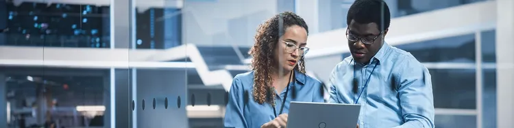 Two people are watching laptop